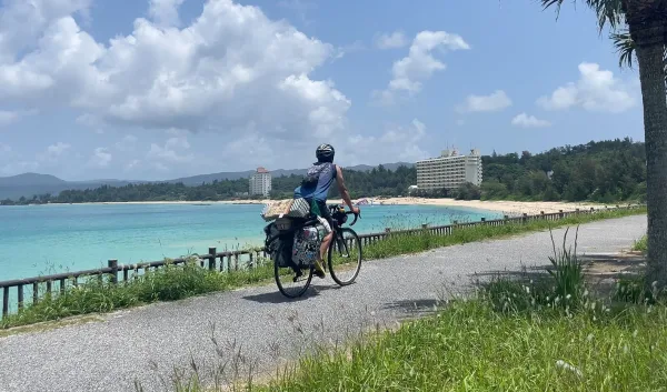 部瀬名岬近くの道を走る自転車旅人